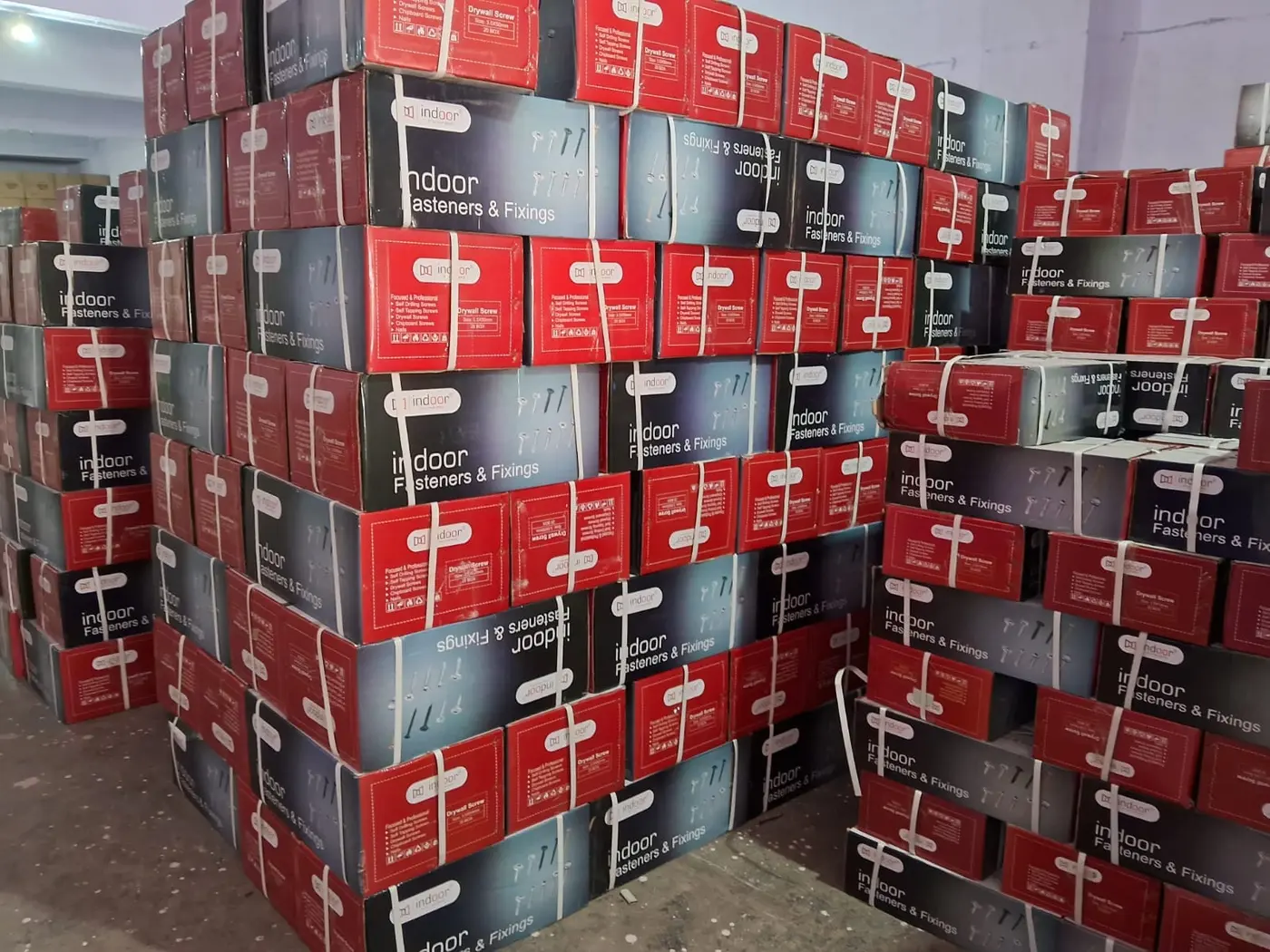 Bulk cartons of drywall screws stacked at the Modern Fastening Solution godown