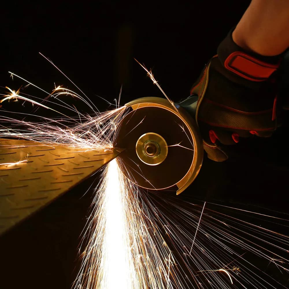 Angle grinder cutting steel with a reinforced cut-off wheel, throwing sparks