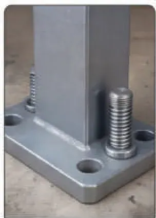 Threaded stud set into a concrete floor at a machine base plate